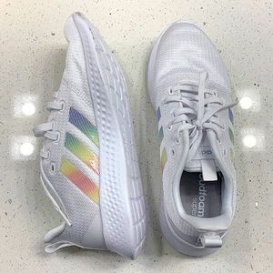These never before worn adidas are white with a rainbow logo and are a 10 1/2.